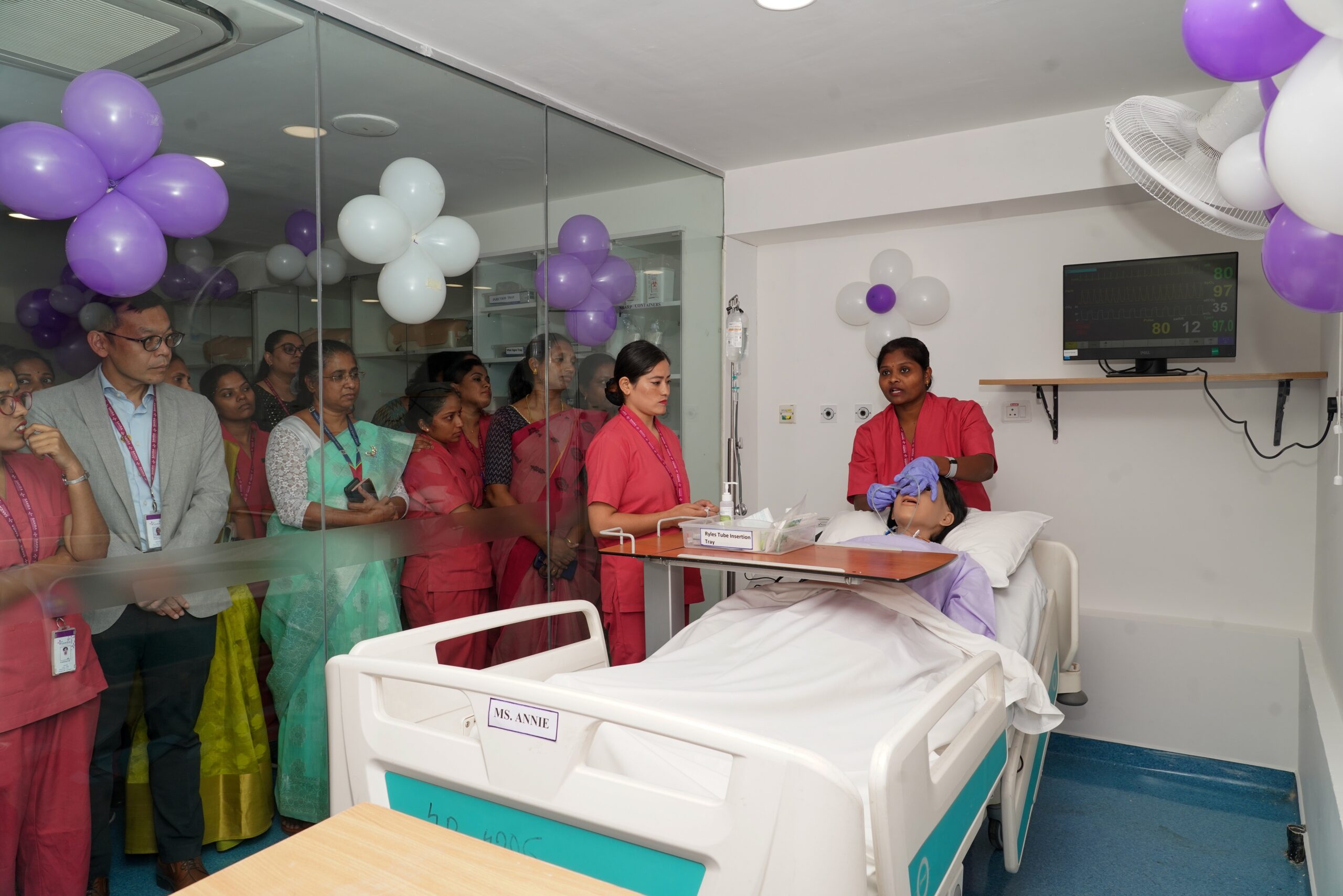 Medical staff demonstration of patient care procedure at Sakra World Hospital with observers