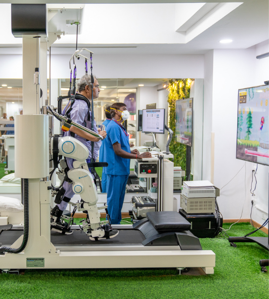 Patient undergoing robotic exoskeleton rehabilitation therapy at Sakra World Hospital with medical supervision